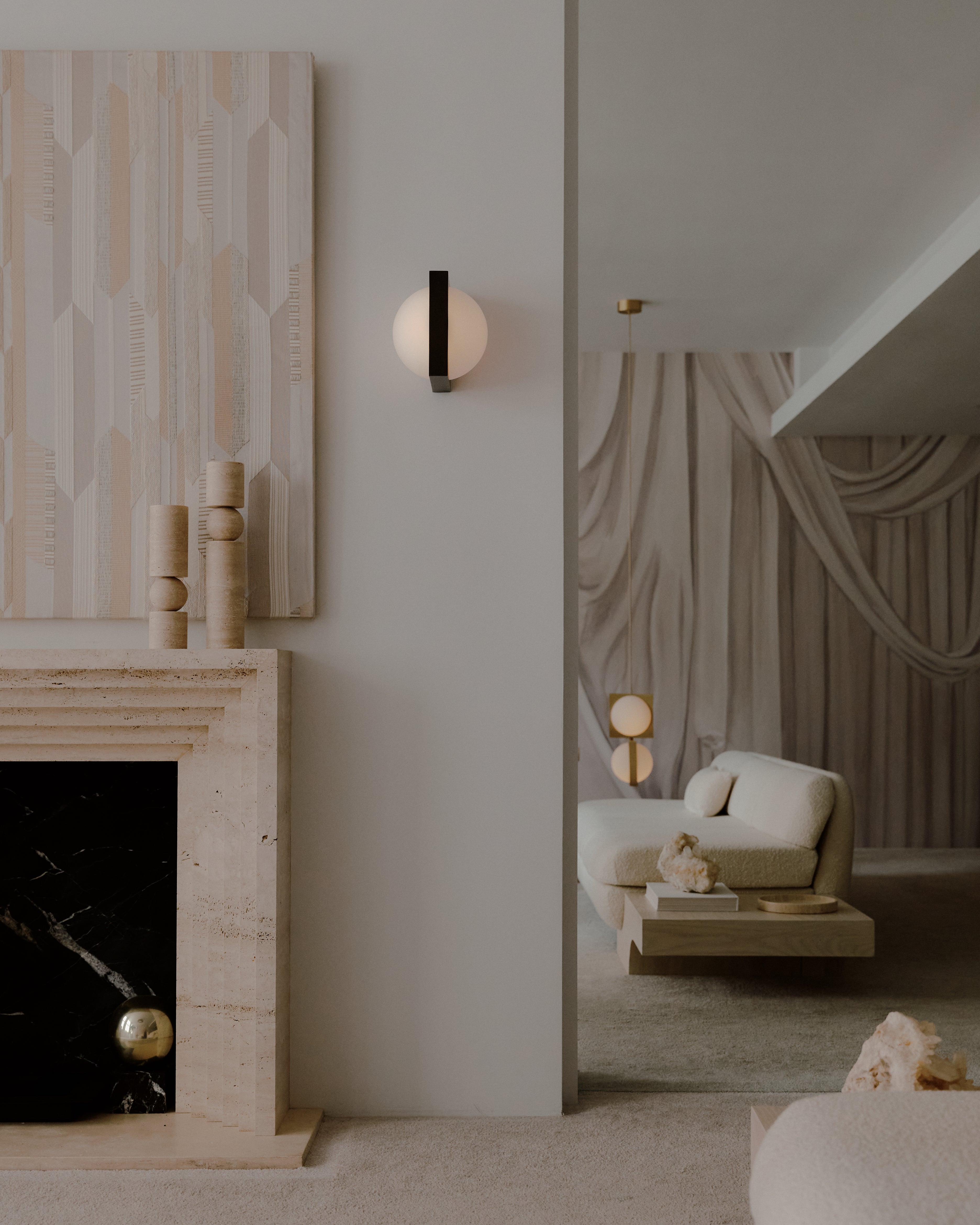 SOLSTICE wall lamp with an opal shade and blackened brass.