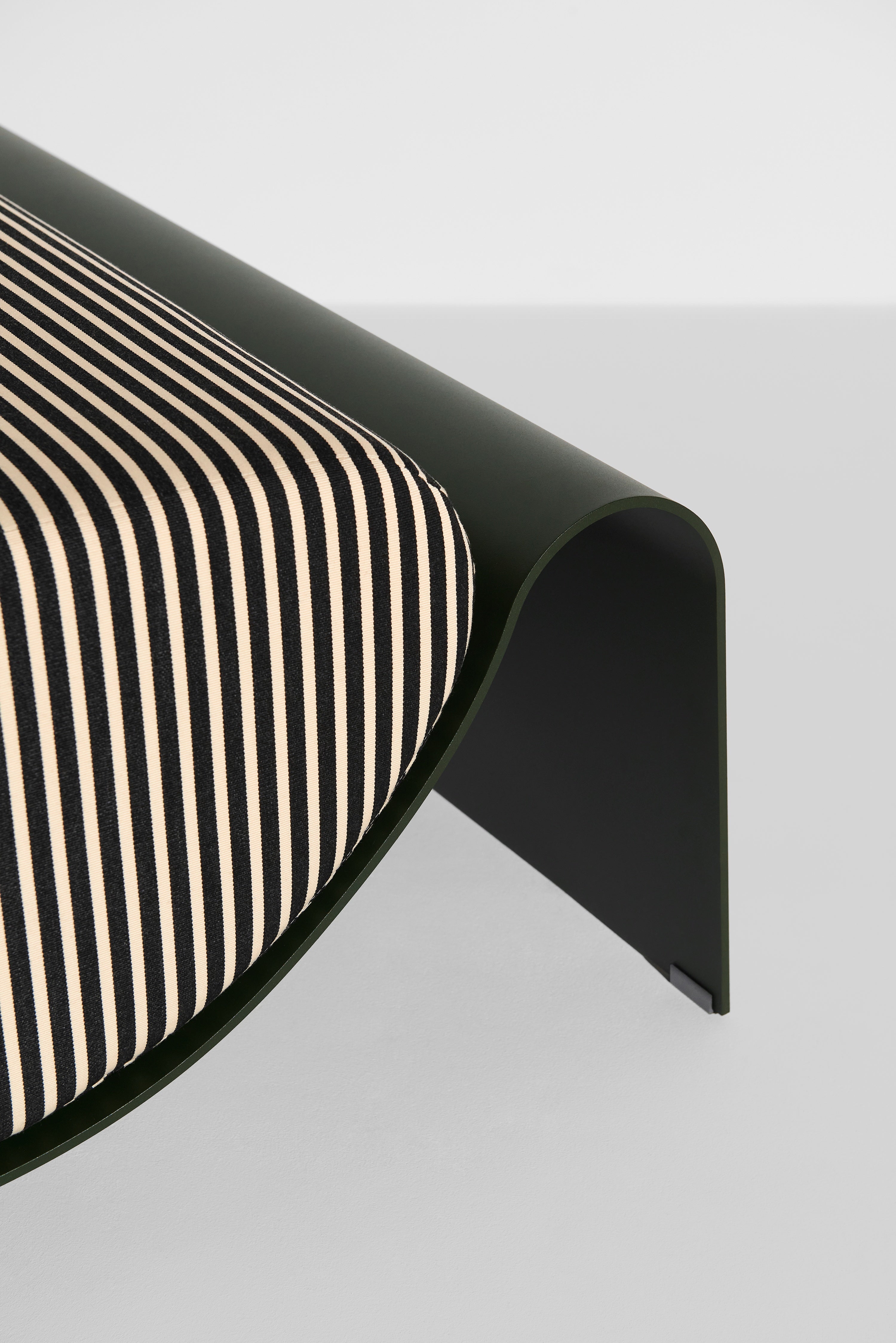 ECLIPSE pouf in dark green with a striped cushion