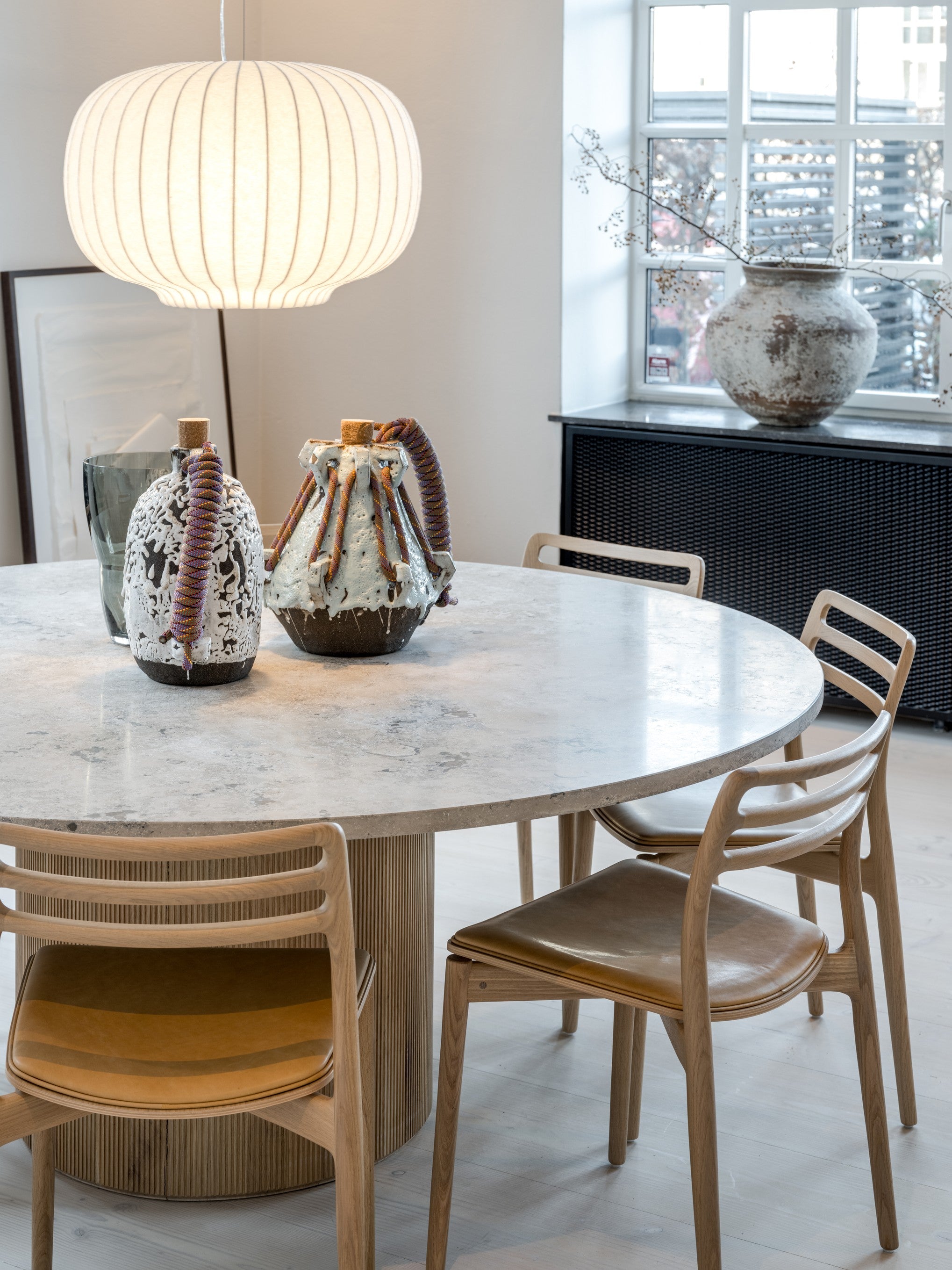Round Table CABIN with a light oak base and a gray limestone top
