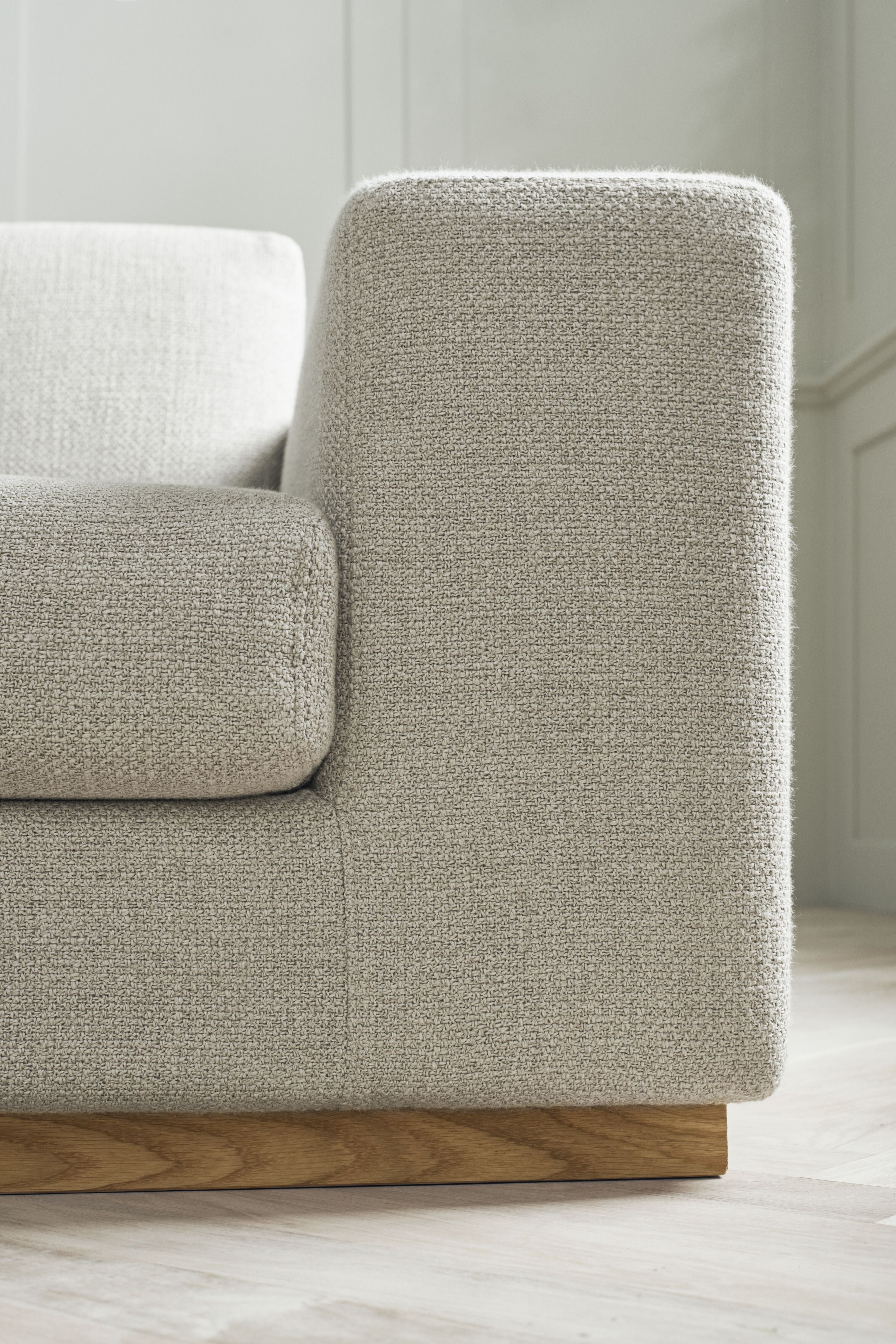 A corner with a sight -sided sepia chaise with an oak base