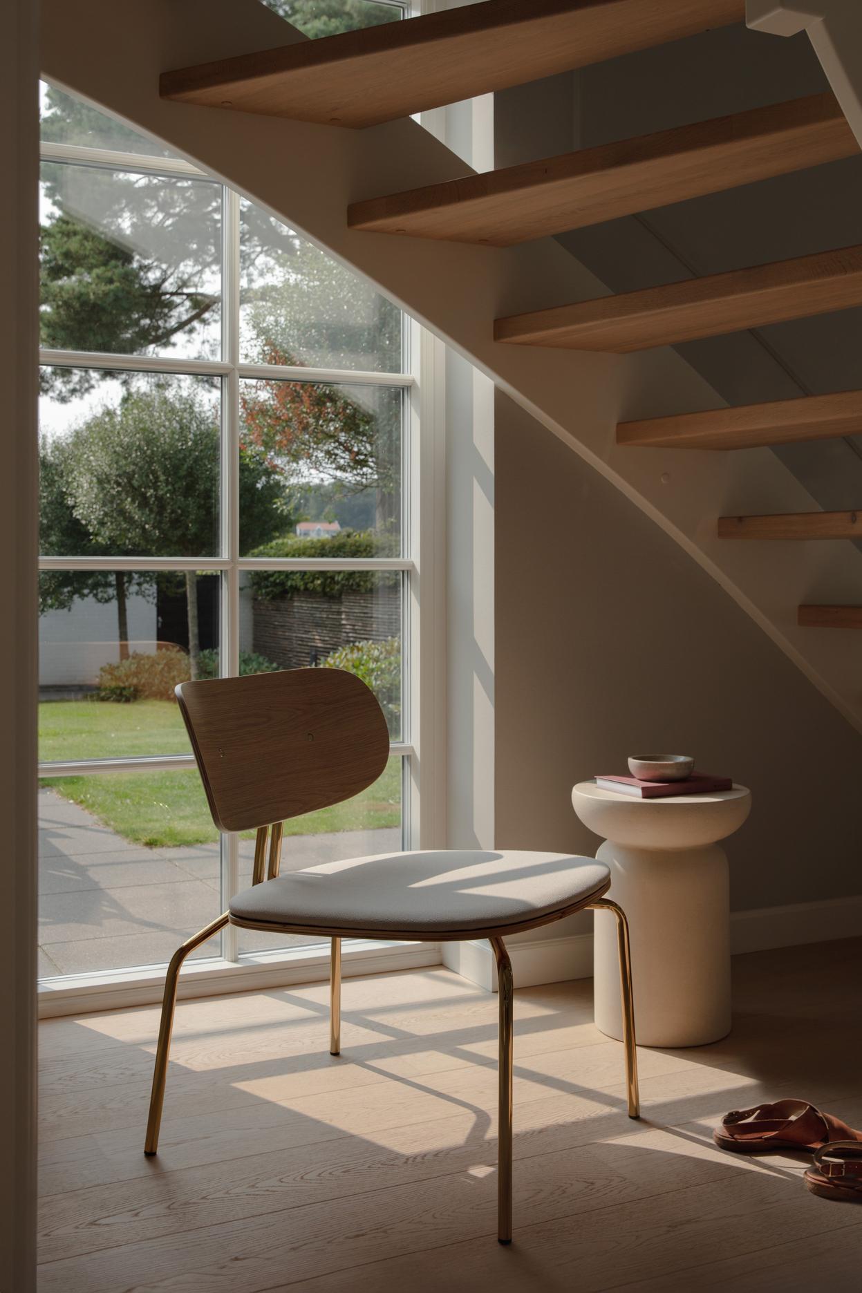Black beige curious armchair with a black base