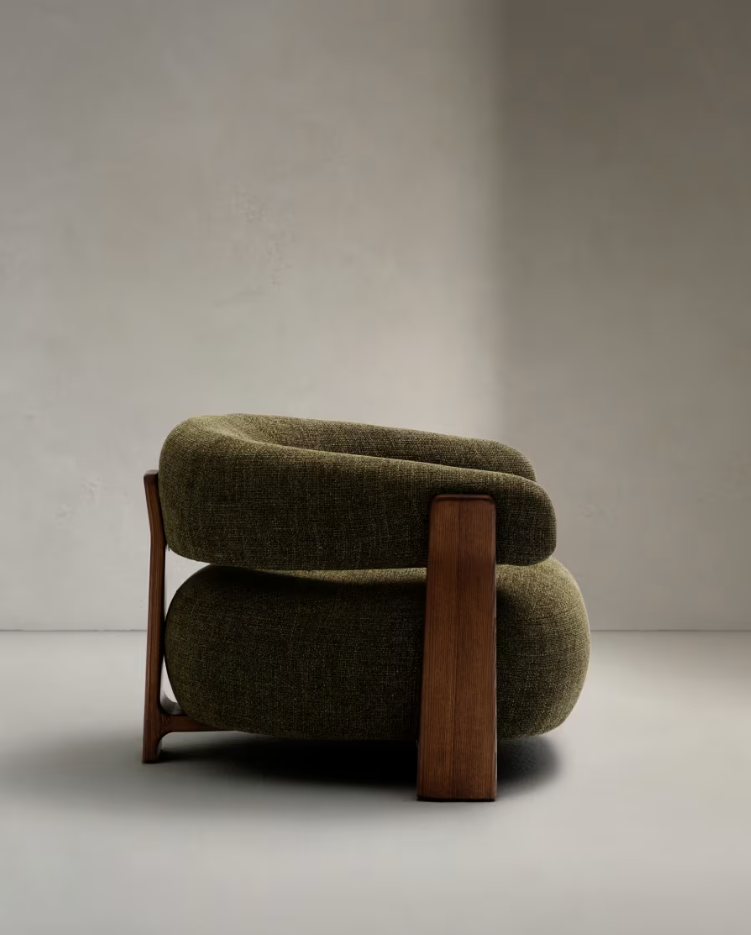 Green green armchair with a dark wooden base