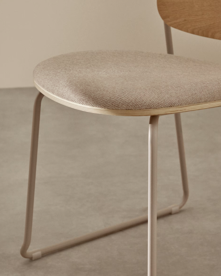 A chair of mela, poplar plywood with a beige szenil seat