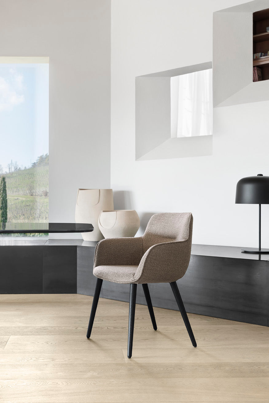 Upholstered SWEEL chair with a dark wooden base