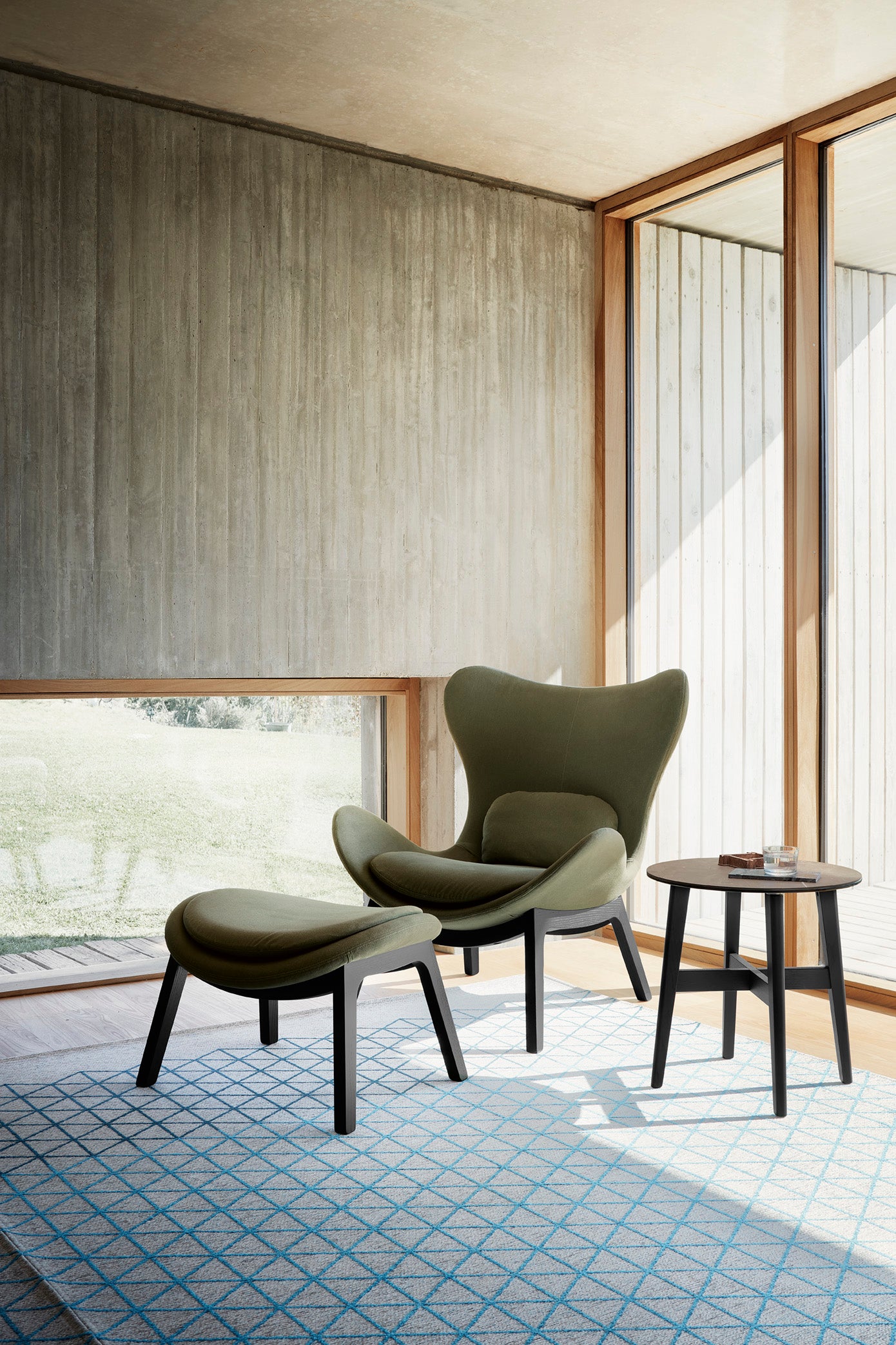Upholstered LAZY armchair with a dark wooden base