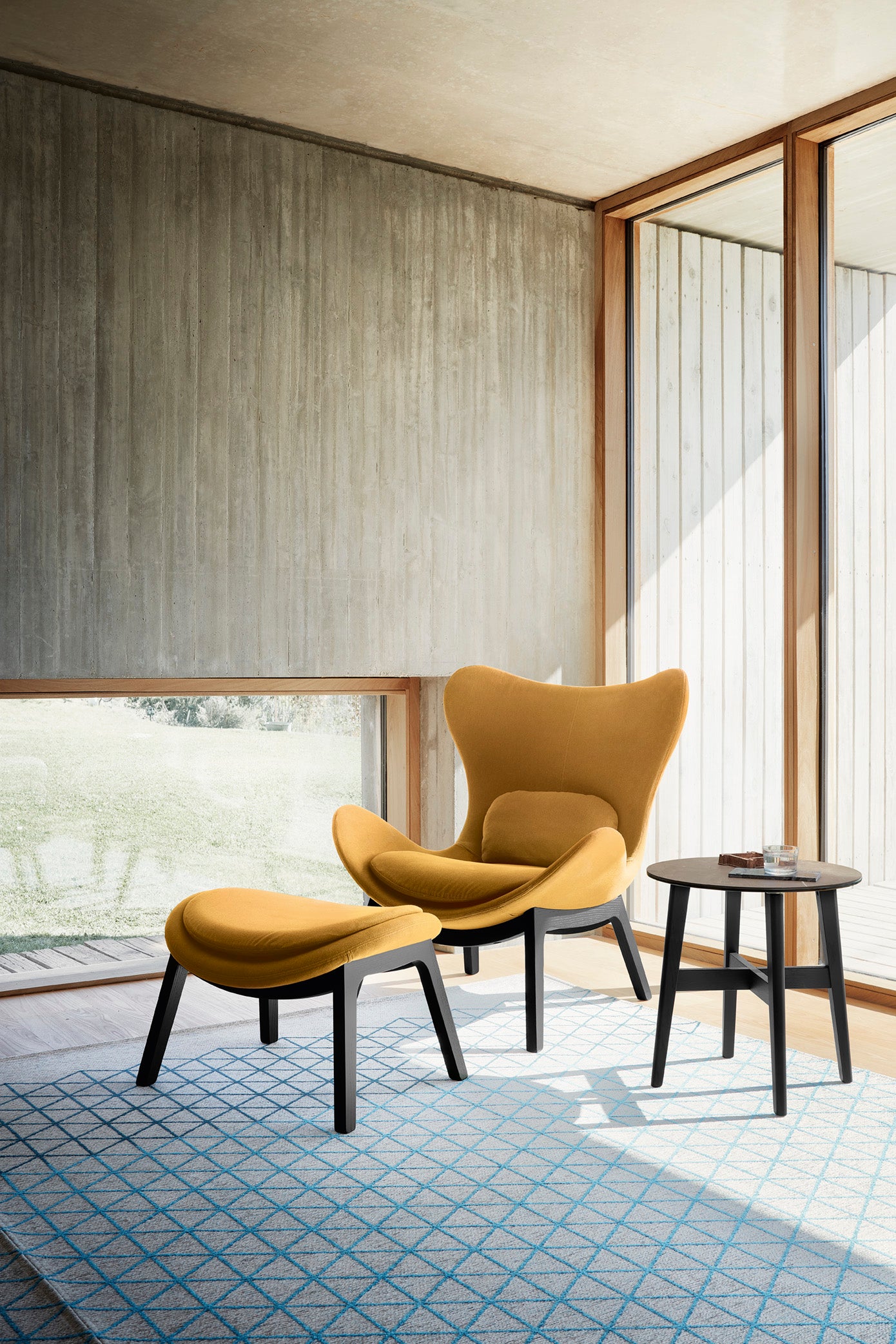 Upholstered LAZY armchair with a dark wooden base