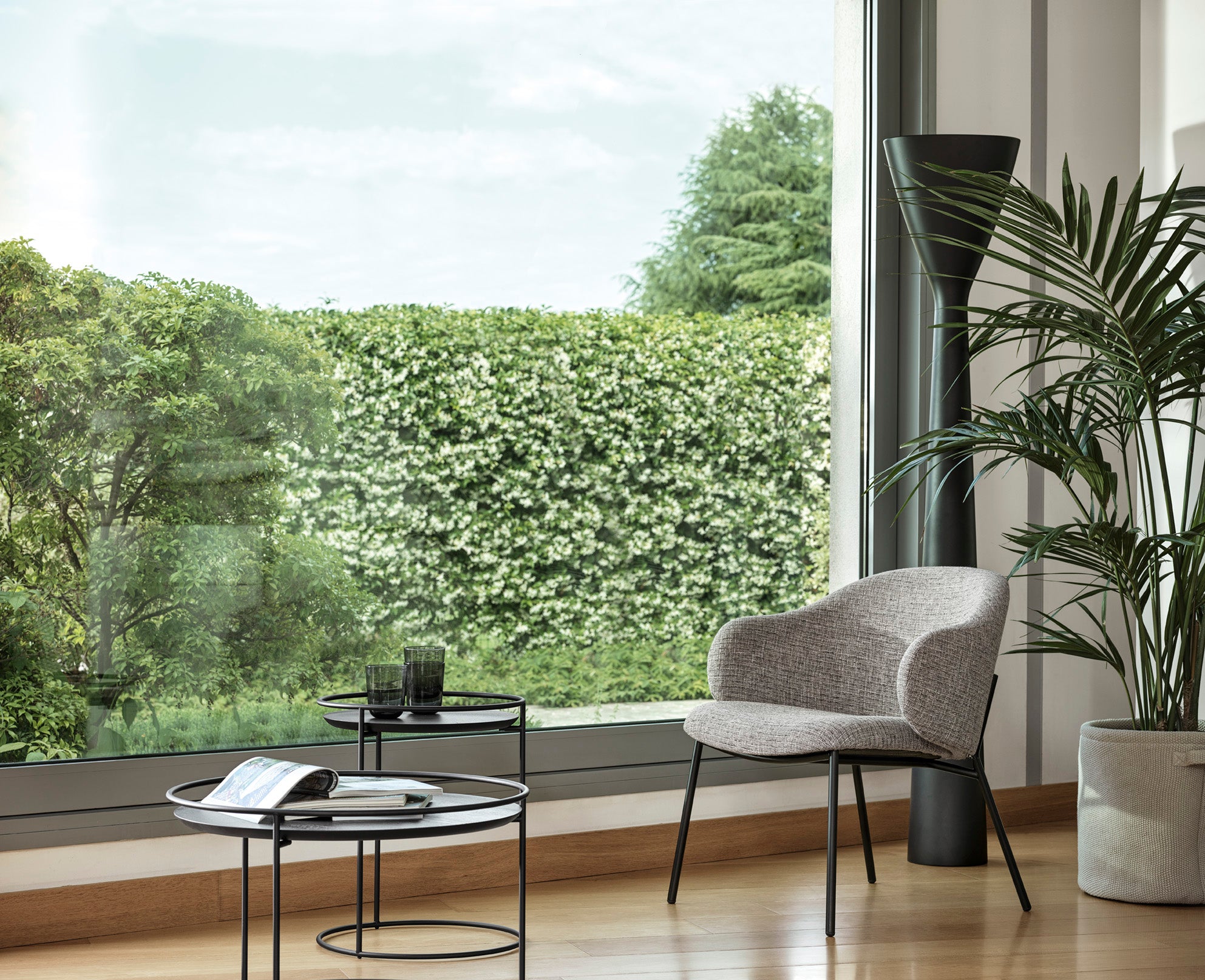 HOLLY upholstered armchair with a black base