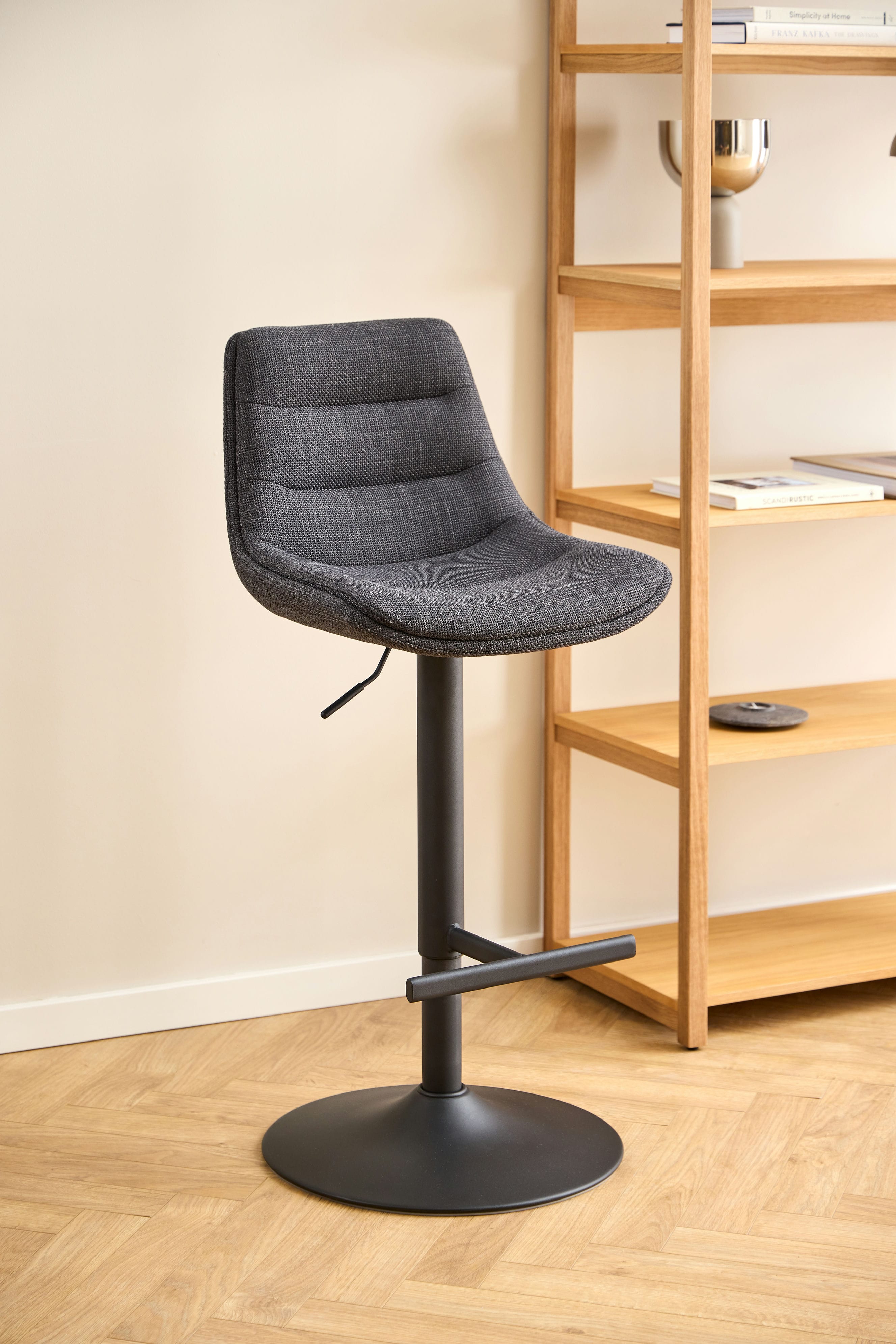 A set of adisa bar chairs with a black base