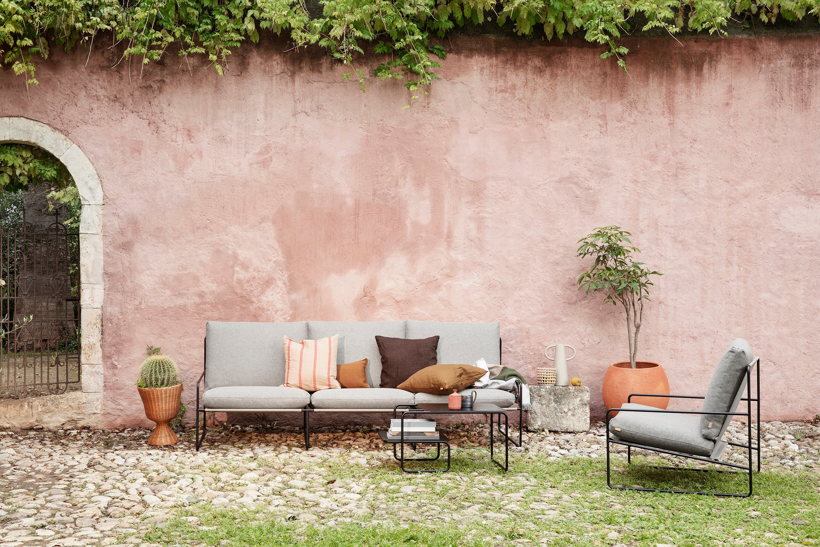 Desert beige external armchair with a black base