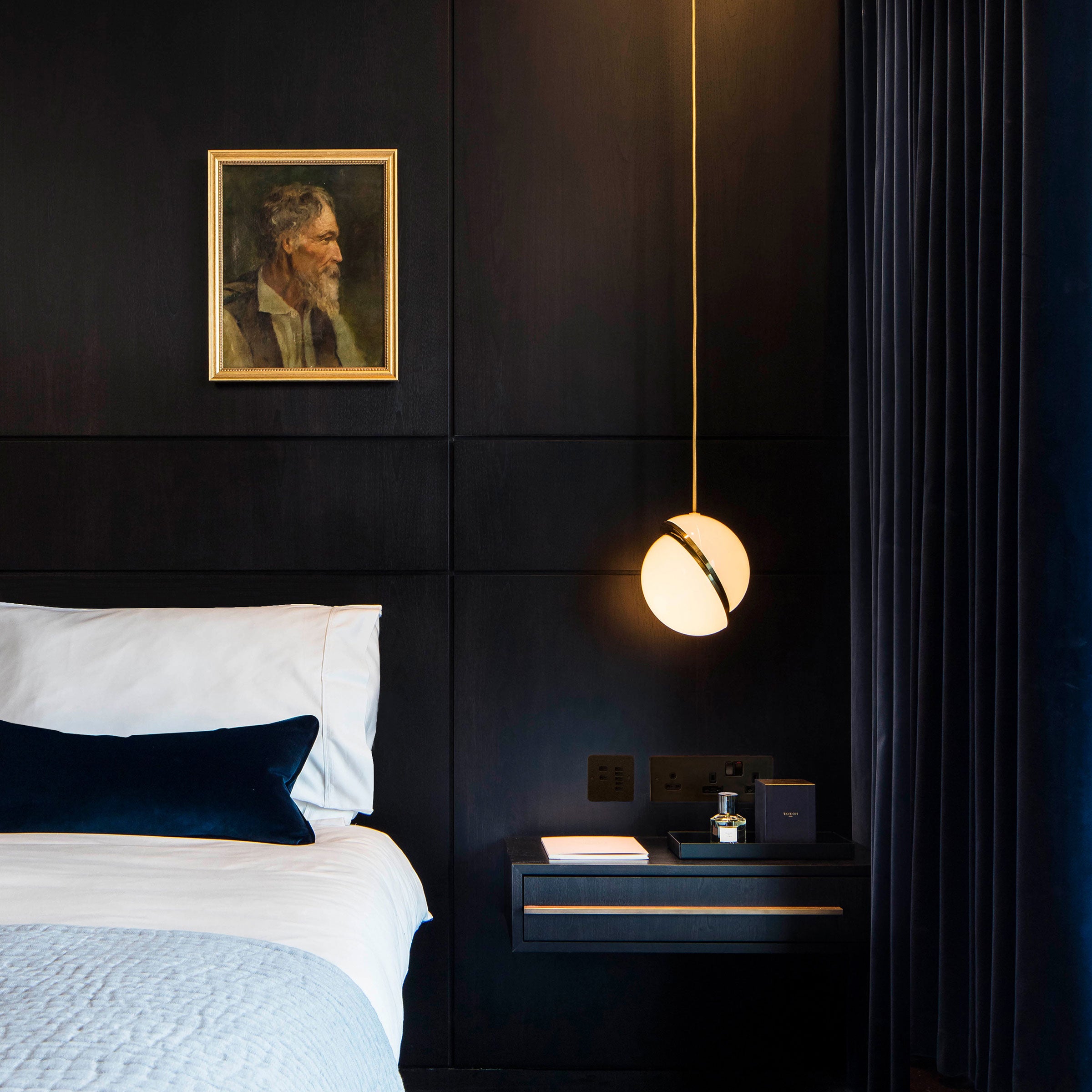 CRESCENT pendant lamp with an opal shade and brass accents.