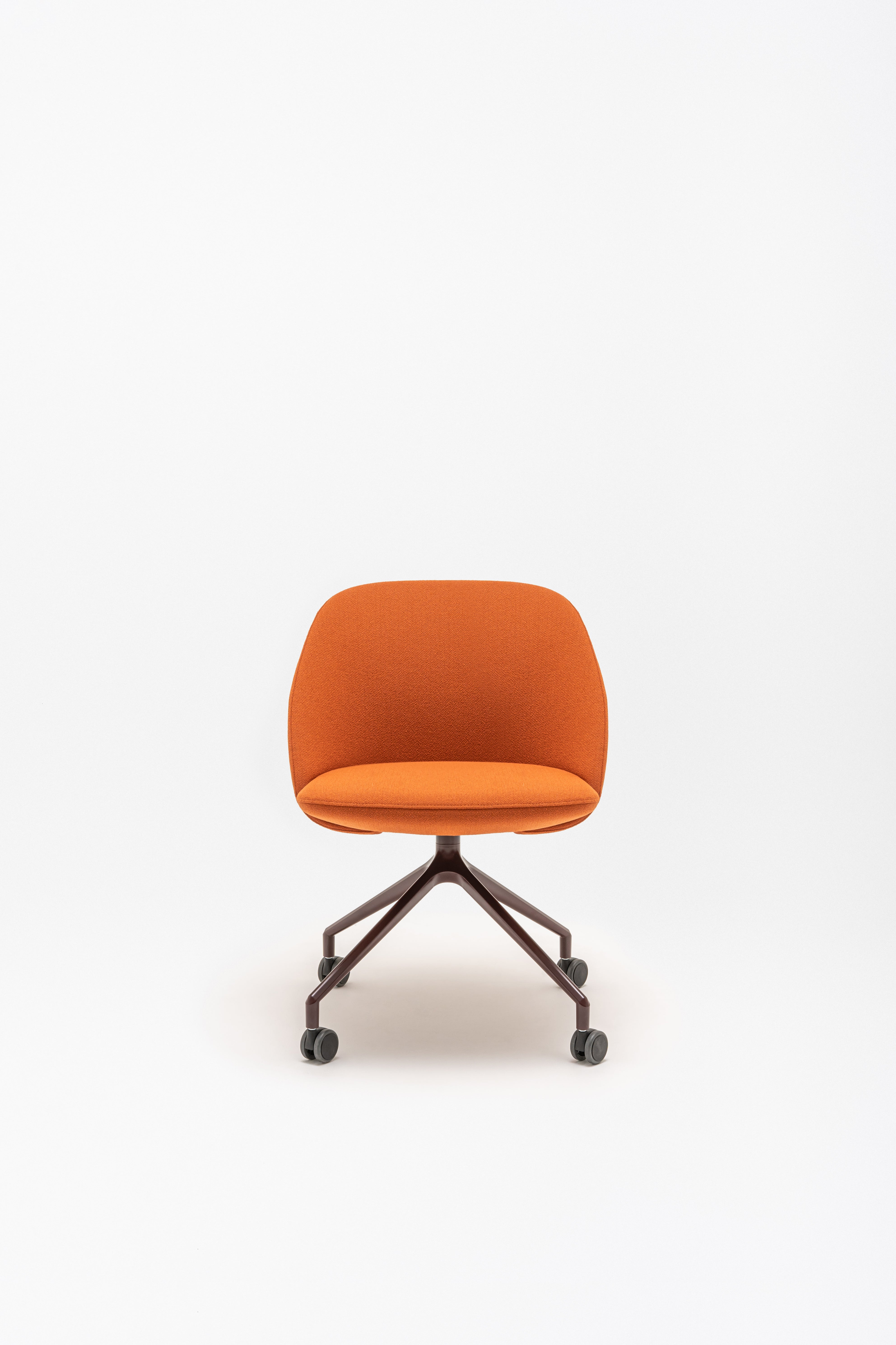 Rotable armchair with low backrest metal parallel base with wheels to a soft surface