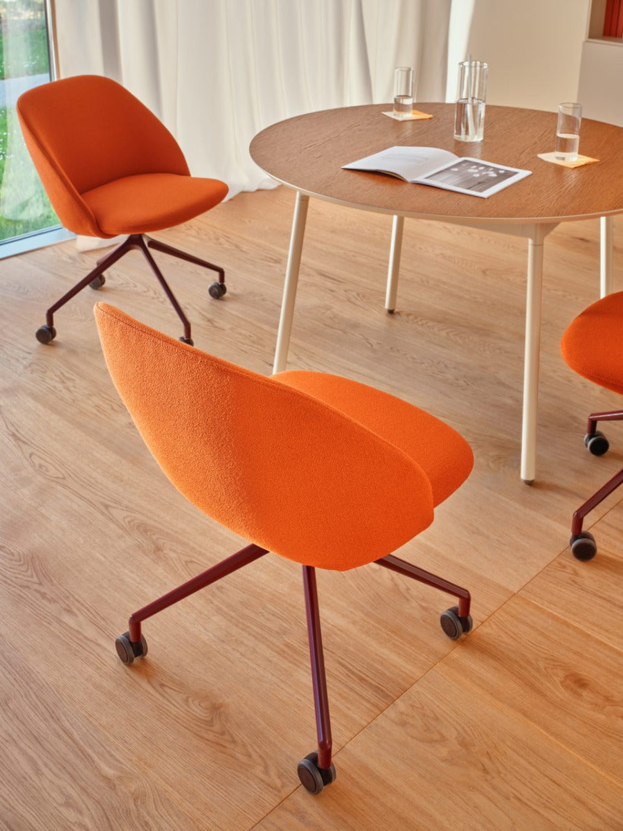 Swivel armchair with low back, a metal parallel base with wheels to a hard surface