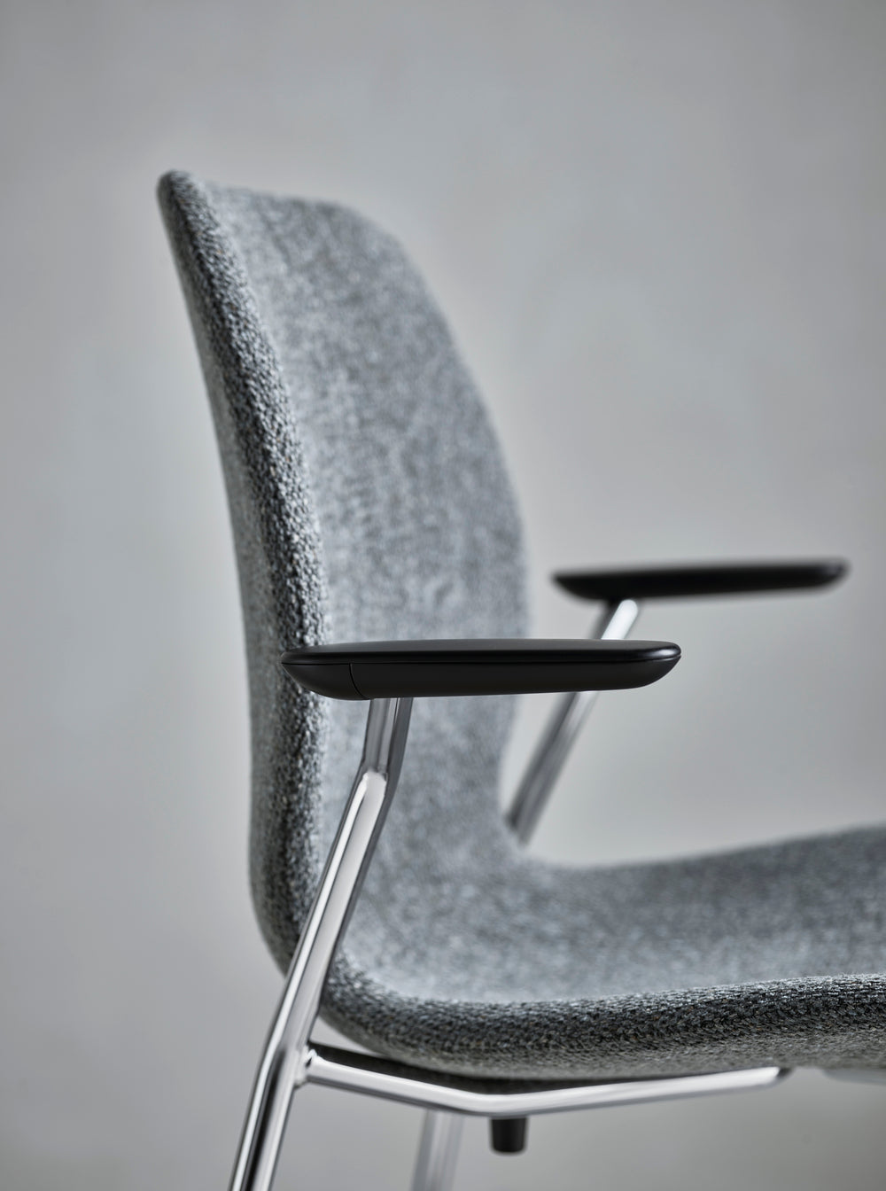 Seed chair upholstered with a gray base